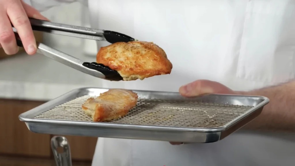 Holding chicken to check if it is Cooked Properly