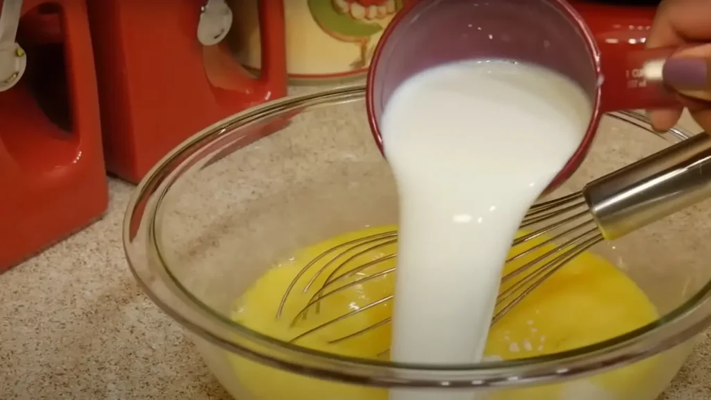 Adding milk to egg mixture